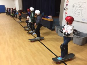 Students learning how to skateboard